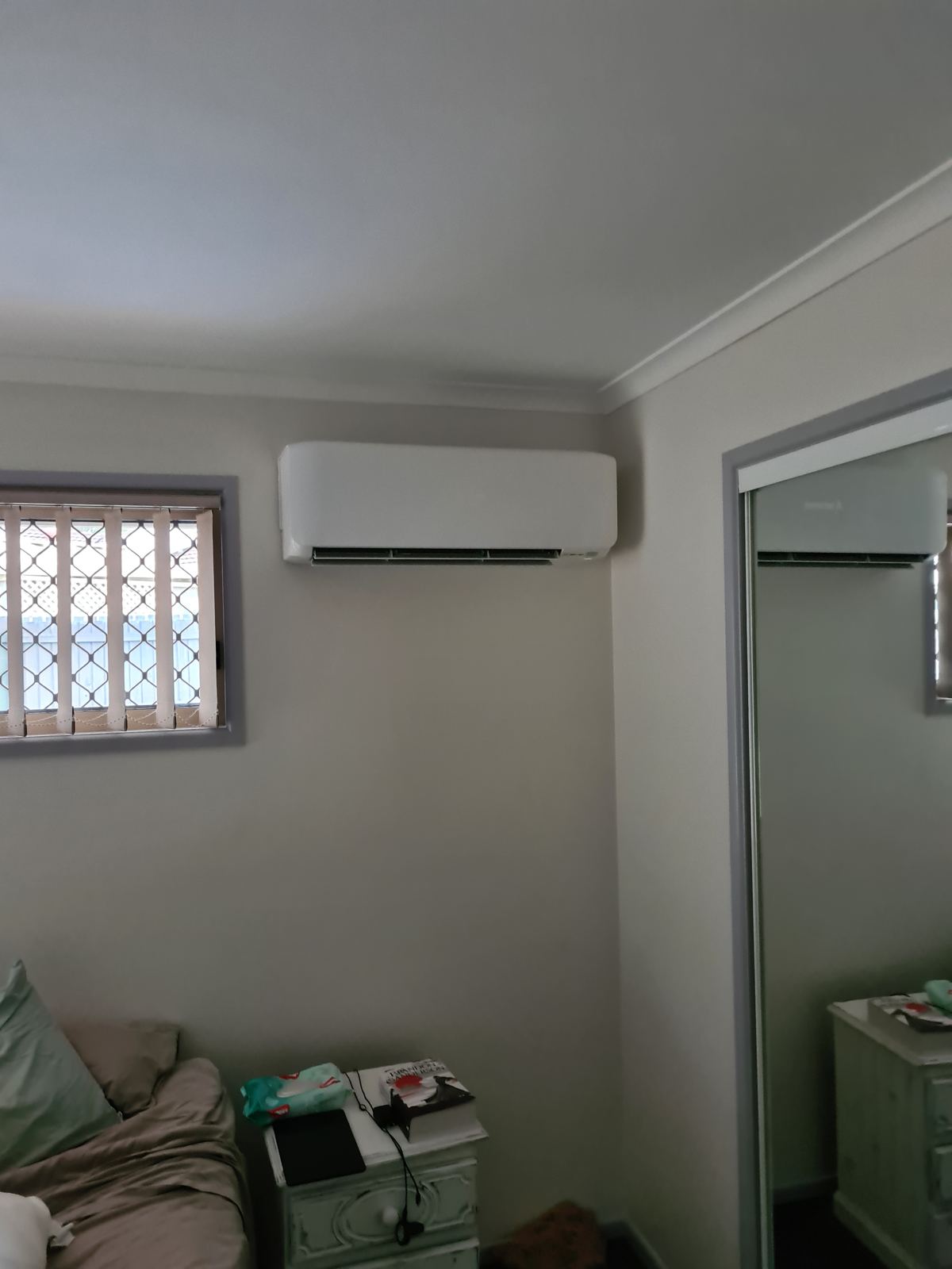 Split system indoor unit above a window