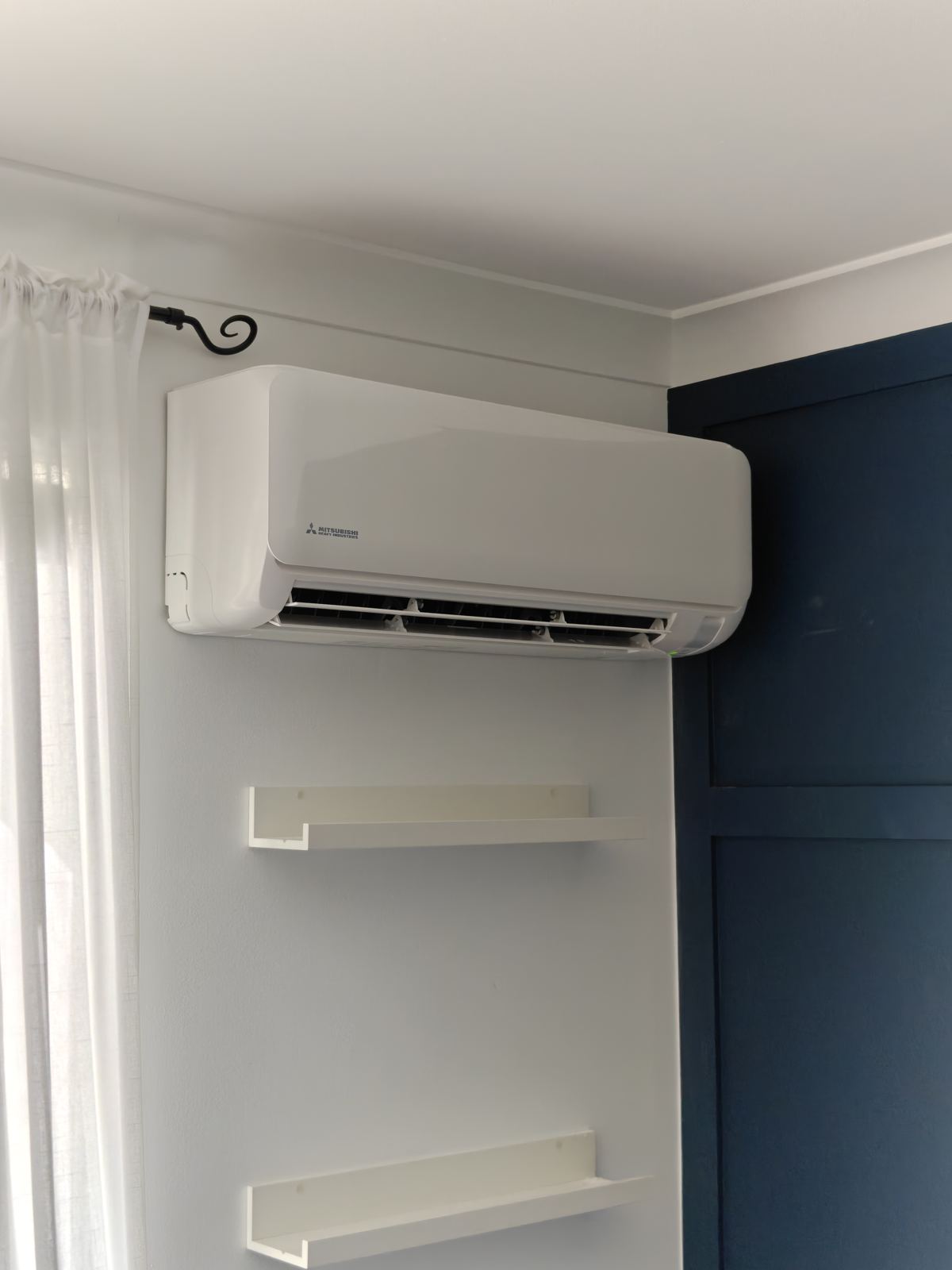 Mitsubishi split system indoor unit above shelves